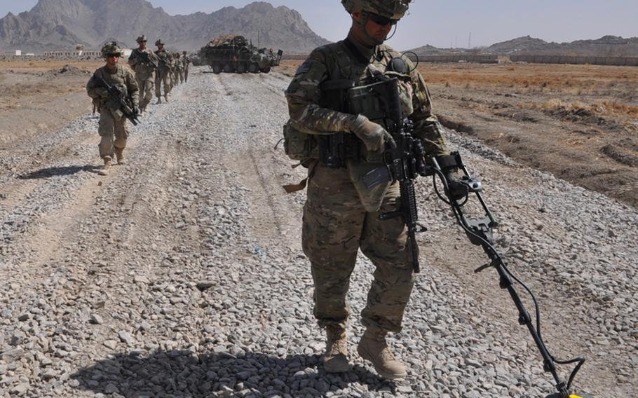 Sgt. Joseph Reap Sr., 32, of Oklahoma City, sweeps for landmines in Pashmul, a hotly contested corner of Kandahar province where insurgents have sown the footpaths and farm fields with bombs.