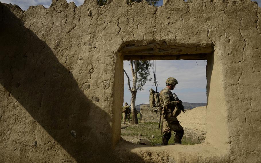 Pfc. Nicholas Tolbert with the 1st Battalion, 501st Infantry Regiment searches an abandoned qalat during a patrol through the village of Maqtab in eastern Afghanistan&#39;s Khost province.