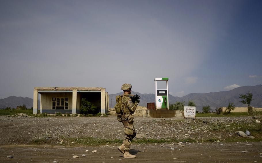 Pfc. Nathan Jackson with the 1st Battalion, 501st Infantry Regiment walks past a gas pump in the village of Danda Faqiran near the Pakistani border in eastern Afghanistan.