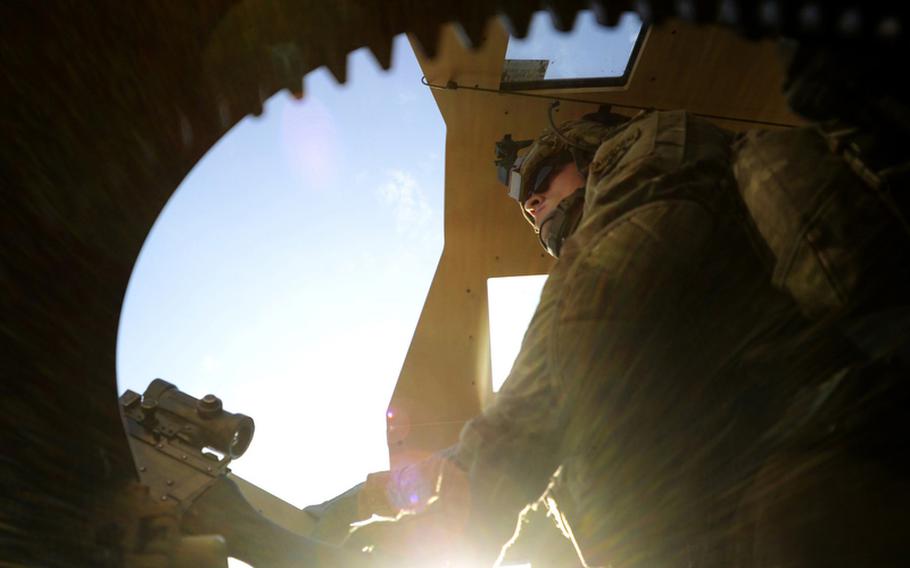 Spc. Levi Page, a mechanic with the 1st Battalion, 501st Infantry Regiment, pulls gunner duty in the turret of a MaxxPro Mine Resistant Ambush Protected vehicle during a patrol through his regiment&#39;s area of responsibility.