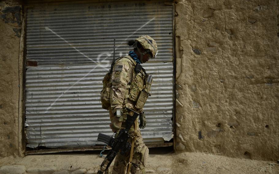 Pfc. Demeatia Mills, a Female Engagement Team member with the 1st Battalion, 501st Infantry Regiment walks through a bazzar in the village of Maktab near the Pakistani border of eastern Afghanistan&#39;s Khost province.