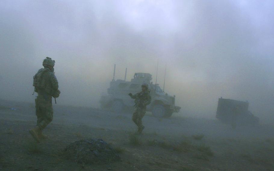 Pathfinders with Company F, 4th Battalion, 101st Aviation Regiment, 159th Combat Aviation Brigade, 101st Airborne Division, link up with their vehicles after being dropped in by Chinook helicopters for a mission on Sept. 23, 2011, in Zabul province, Afghanistan.