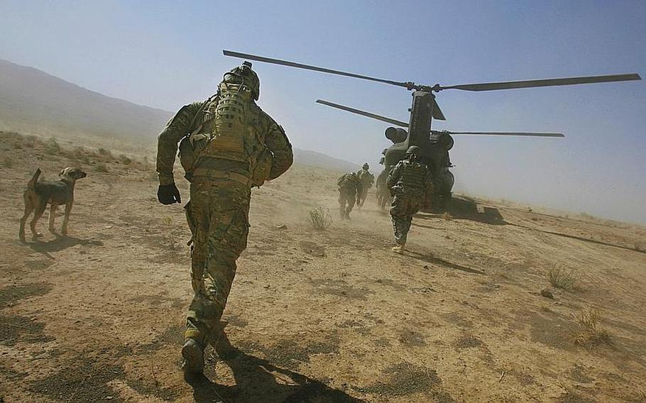 1st Lt. Weston Walrond of Company F, 4th Battalion, 101st Aviation Regiment, 159th Combat Aviation Brigade, 101st Airborne Division, runs to a Chinook helicopter following a mission in the village of Loy Shur on Sept. 23, 2011, in Zabul province, Afghanistan.