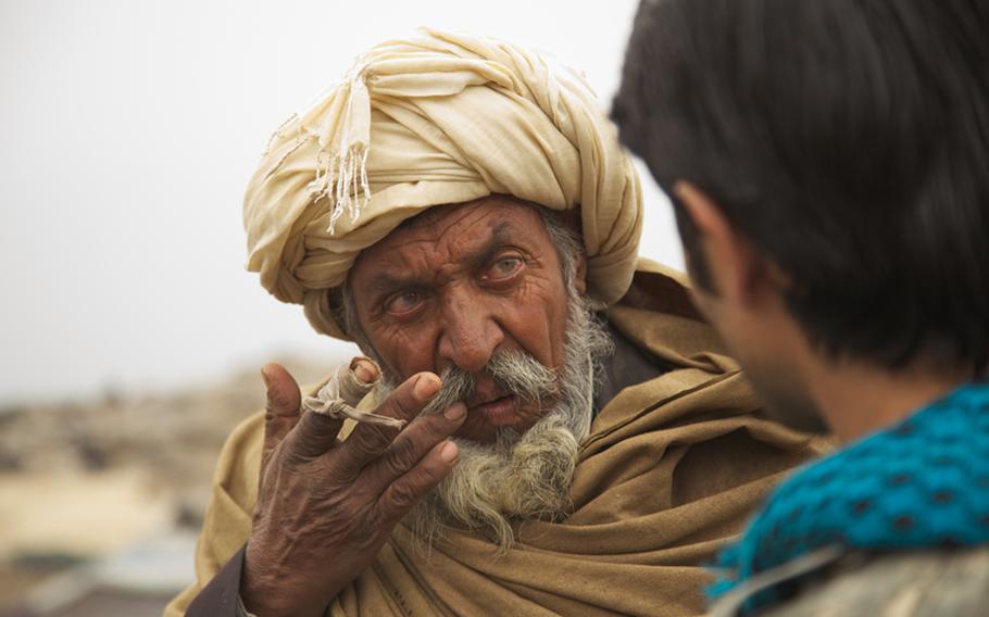 An elder from the Kuchi tribe in Afghanistan listens as an interpreter explains a U.S. Army medic's recommendation for treating his wife's painful scalp cysts. The condition likely resulted poor hygiene, said Spc. Victor Cornejo, 34, a medic from Palm Springs, Calif., who examined the woman.