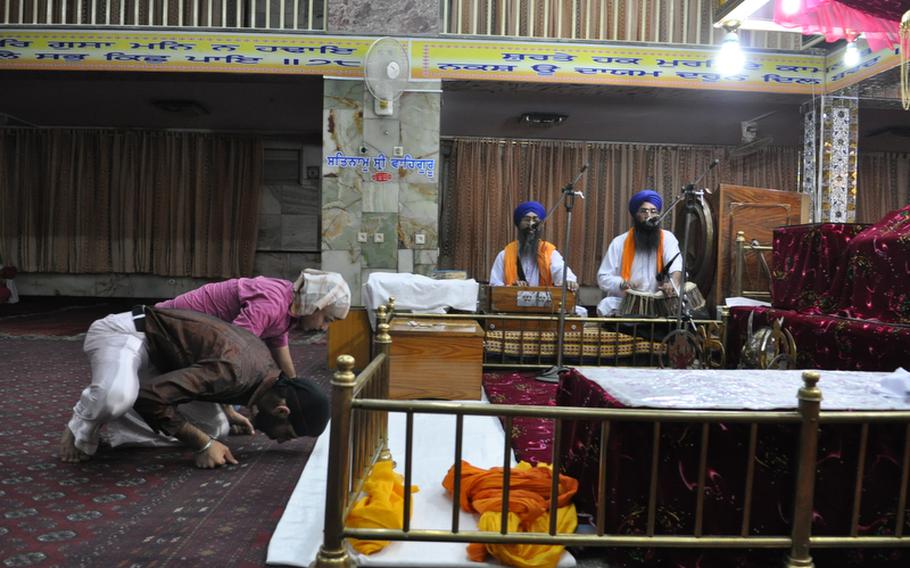 Two men pray during Sikh services at a Kabul temple. The Sikh and Hindu community has been in Afghanistan for centuries but harassment, poverty and violence have pushed most of its members to leave Afghanistan.