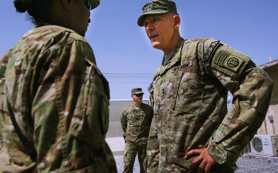 Army Maj. Gen. James L. Huggins Jr., commander of Regional Command South, speaks to a soldier following the Sept. 2 Transfer of Authority ceremony Kandahar Airfield, Afghanistan. Huggins, of the 82nd Airborne Division, transferred authority of RC-South to Maj. Gen. Robert B. Abrams of the 3rd Infantry Division.