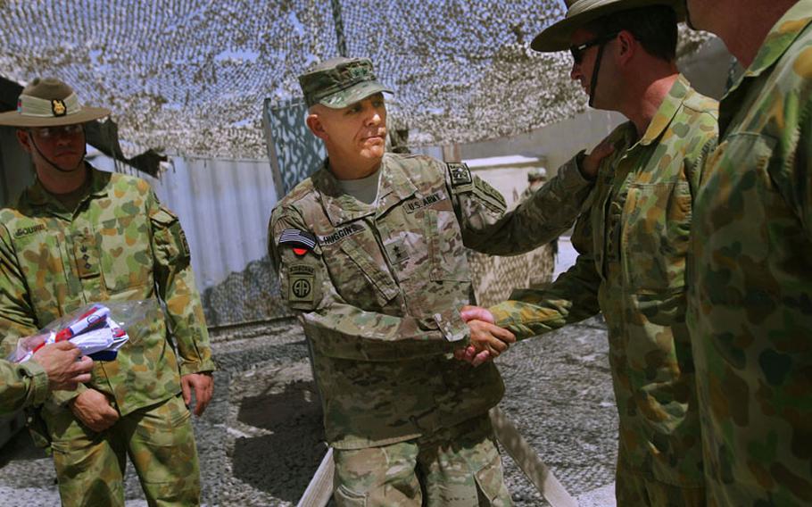 The commander of Regional Command-South, Maj. Gen. James L. Huggins Jr., shakes hands with Australian troops following a Transfer of Authority ceremony Kandahar Airfield, Afghanistan on Sept. 2. Huggins, of the 82nd Airborne Division, transferred authority to Maj. Gen. Robert B. Abrams of the 3rd Infantry Division.
