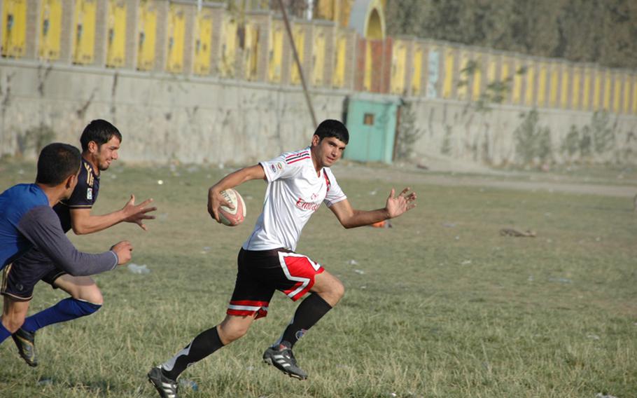 An Afghan rugby player makes a line break during practice at Kabul&#39;s Chaman-i-Huzuri park on Sunday.