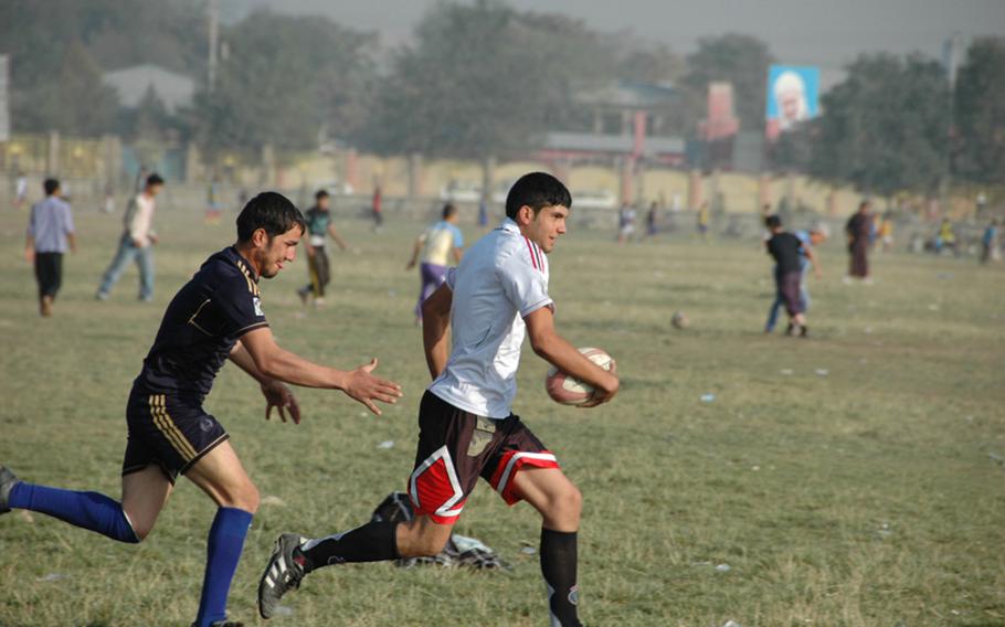 An Afghan rugby player prepares to tackle a runner during practice at the Chaman-i-Huzuri park in Kabul on Sept. 23, 2012.