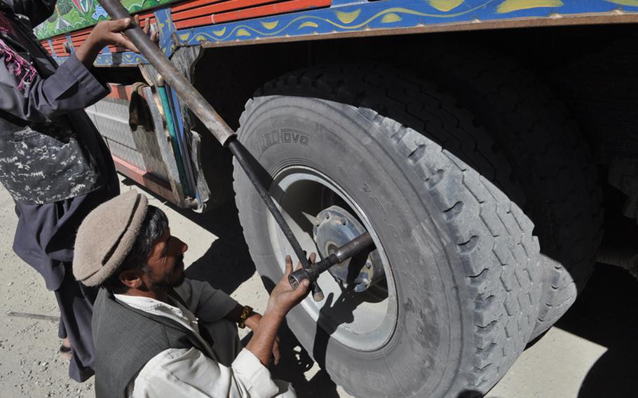 Truckers work on their rig after crossing through the Salang Tunnel, at an elevation of more than 11,000 feet, one of the highest vehicle tunnels in the world. The Soviet-era throughway is in dire need of repairs and the U.S. Army Corps of Engineers recently awarded a $12.8 million contract to improve the tunnel, which is key for both NATO forces in Afghanistan and local business.