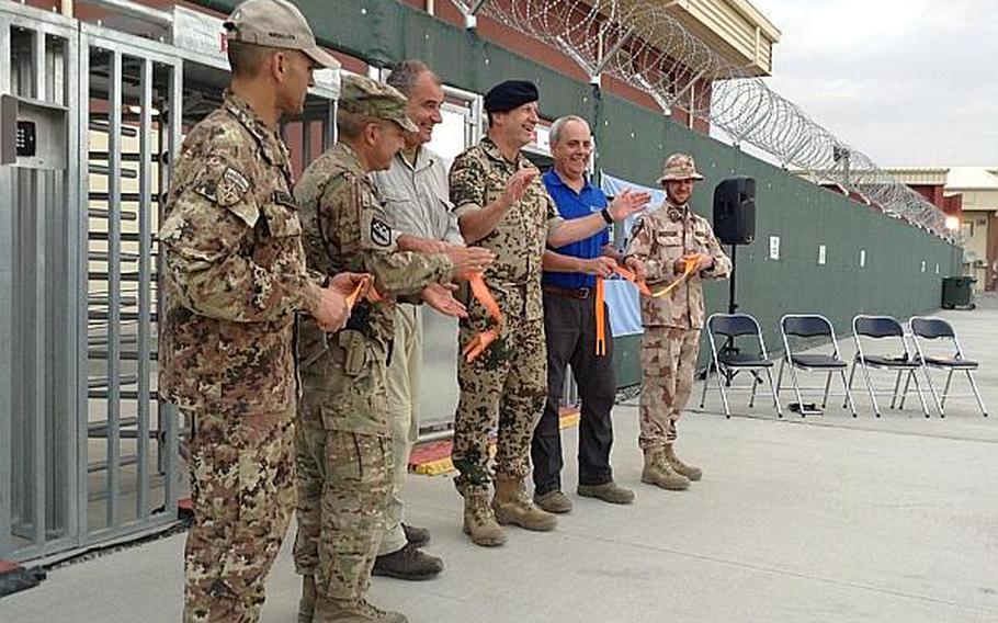 ISAF Joint Command deputy commander Maj. Gen. Dieter Warnecke and other ISAF officials cut a ribbon to officially open the new Afghanistan Mission Network Operations Center on July 12 in Kabul. Warnecke said the new $8 million facility shows NATO's commitment to stay in Afghanistan at least into 2015.