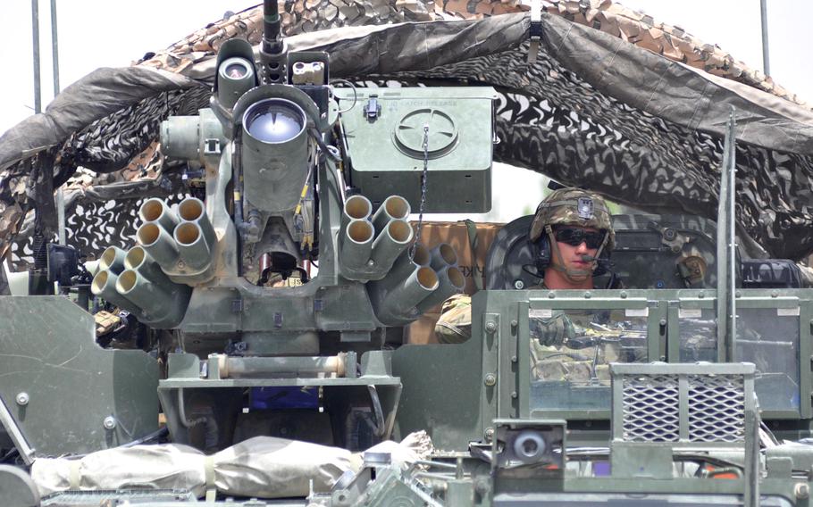 A soldier peers out of a Stryker vehicle as his convoy rides down the "Panjwai 500," the East-West thoroughfare from Forward Operating Base Shoja to FOB Zangabad. The leaders of 1st Squadron, 2nd Cavalry Regiment are finding that Panjwai is a difficult social puzzle to understand.