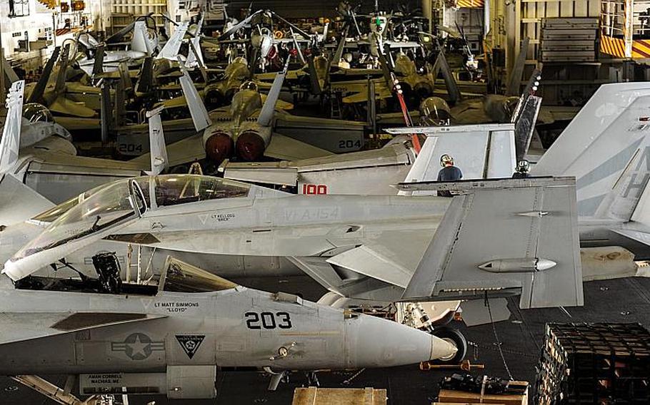 Aircraft assigned to Carrier Air Wing (CVW) 11 sit in the hangar bay aboard the USS Nimitz (CVN 68) Sept. 23 2013 while the ship sails in the U.S. 5th Fleet area of responsibility.