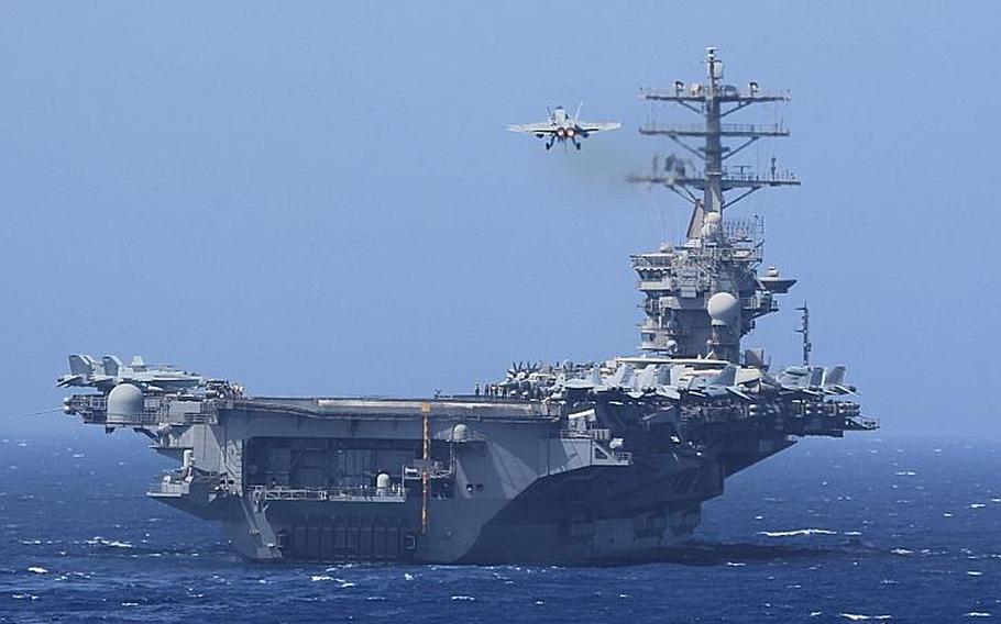 An F/A-18E Super Hornet prepares to land on the flight deck of the USS Nimitz (CVN 68) after participating in an air power demonstration on Oct. 5, 2013 while in the U.S. 5th Fleet area of responsibility.