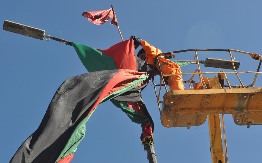 A city worker untangles an Afghan flag in Kabul on a road leading the building hosting the Loya Jirga, a council of elders and local leaders from around the country, which begins Wednesday. The council will consider a proposed U.S.-Afghan security accord that must be approved for the U.S. to keep troops in the country beyond 2014. 

Heath Druzin/Stars and Stripes