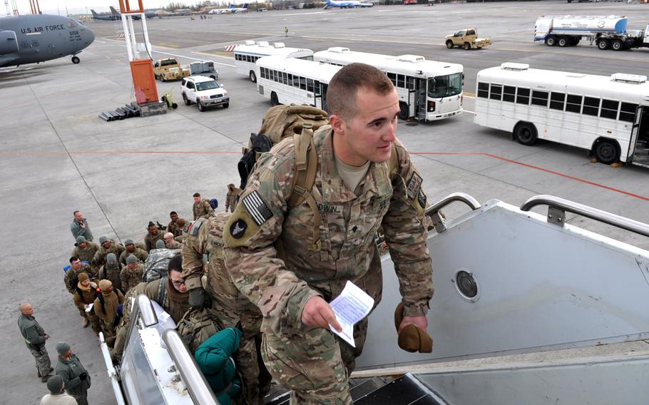 Troops on their way home after deployments in Afghanistan board a flight at Manas International Airport near Bishkek, Kyrgyzstan. After serving as the "Gateway to Afghanistan" for more than a decade, the U.S. Air Foce facility at Manas will close down in a matter of months.