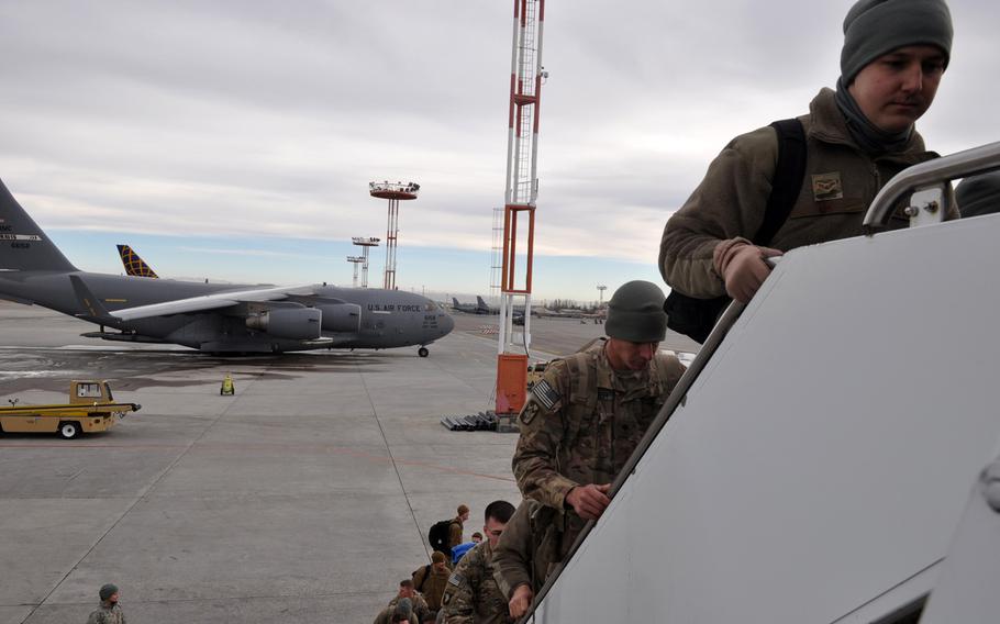 Service members board an aircraft at Manas International Airport in Kyrgyzstan after leaving deployments in Afghanistan. The U.S. Air Force facility at the airport has operated as a key logistics hub since the beginning of the war in Afghanistan.