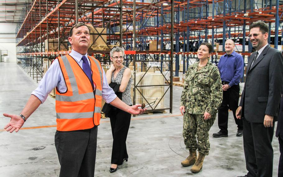 Defense Logistics Agency Distribution Bahrain Deputy Commander Jerry Brown shows off one of the new climate controlled warehouses to DLA officials and guests touring the new distribution center in Bahrain. The new location, in an industrial part of Hidd, offers DLA about 297,000 square feet of space to store parts for ships, aircraft and equipment in support of U.S. military forces in the region.