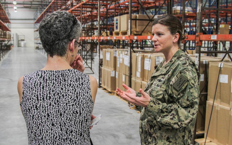 Cmdr. Julie Hunter, commander of Defense Logistics Agency Distribution Bahrain, gives DLA Distribution Deputy Commander Twila Gonzales a tour of DLA's new distribution center in Bahrain.  The new location offers DLA about 297,000 square feet of space to store parts for ships, aircraft and equipment in support of U.S. military forces in the region.