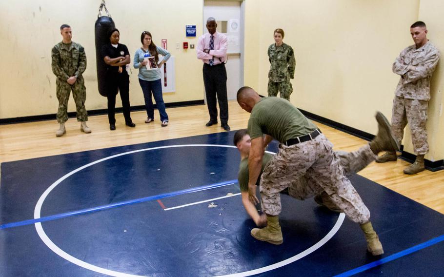 Sgt. William Rivera takes down Cpl. Cole Wyrick during a demonstration Oct. 1, 2014, of a self defense class Marines from the Fleet Anti-terrorism Security Team put together for Naval Support Activity Bahrain's Sexual Assault Prevention and Response program.