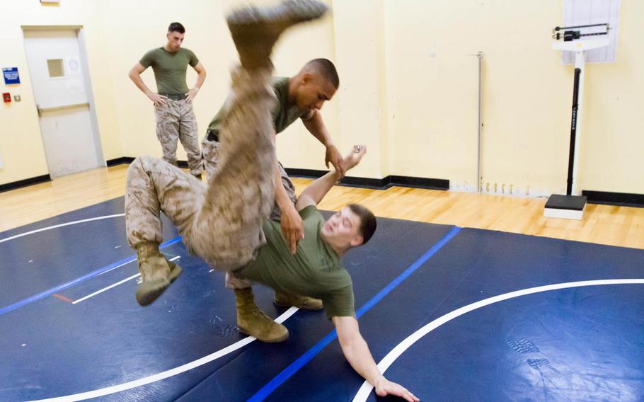 Sgt. William Rivera takes down Cpl. Cole Wyrick during a demonstration Oct. 1, 2014,  of a self defense class Marines from the Fleet Anti-terrorism Security Team put together for Naval Support Activity Bahrain's Sexual Assault Prevention and Response program.