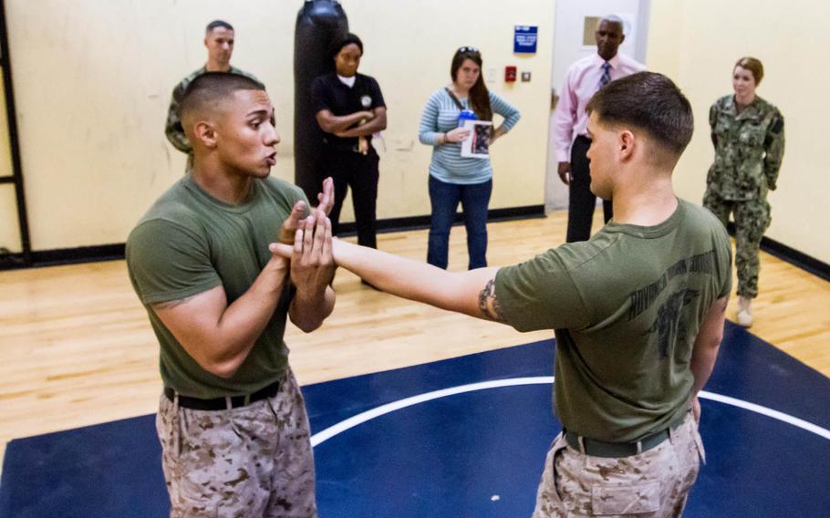 Sgt. William Rivera, left, demonstrates a self defense technique by countering a simulated attack from Cpl. Cole Wyrick on Oct. 1, 2014. U.S. Marines from the Fleet Anti-terrorism Security Team based in Bahrain have designed a curriculum that teaches defensive techniques meant as a last resort to prevent a sexual assault.