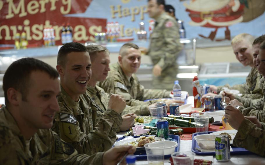 American soldiers enjoy a Christmas meal at the Kabul headquarters of the international military coalition in Afghanistan on Christmas Day, 2014. The coalition is set to scale down to just 12,000 troops by the end of the year. 