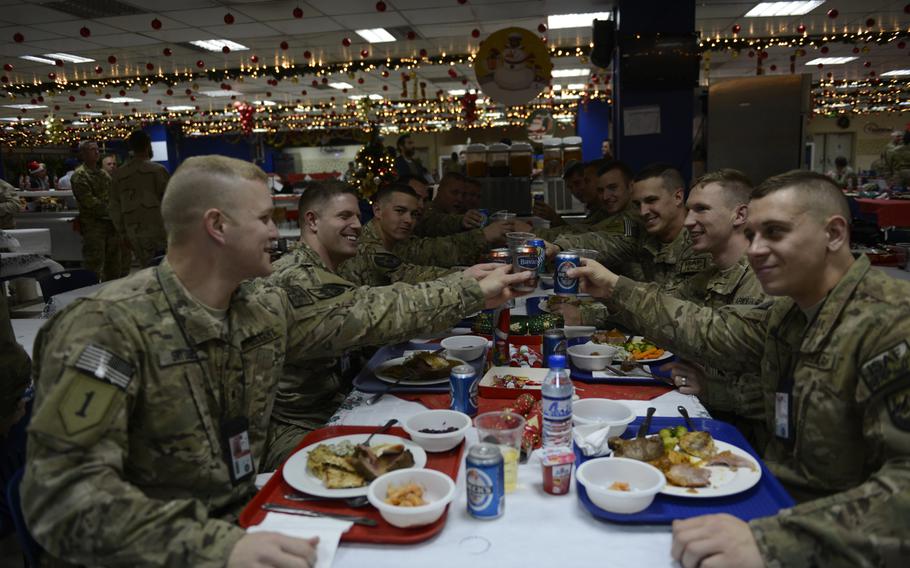 Soldiers toast with nonalcoholic beer on Christmas Day 2014 in a dining hall at the headquarters of the U.S.-led International Security Assistance Force. It's the 14th Christmas U.S. troops have spent in Afghanistan and there will be at least two more, with a limited number of troops staying in the country through 2016. 