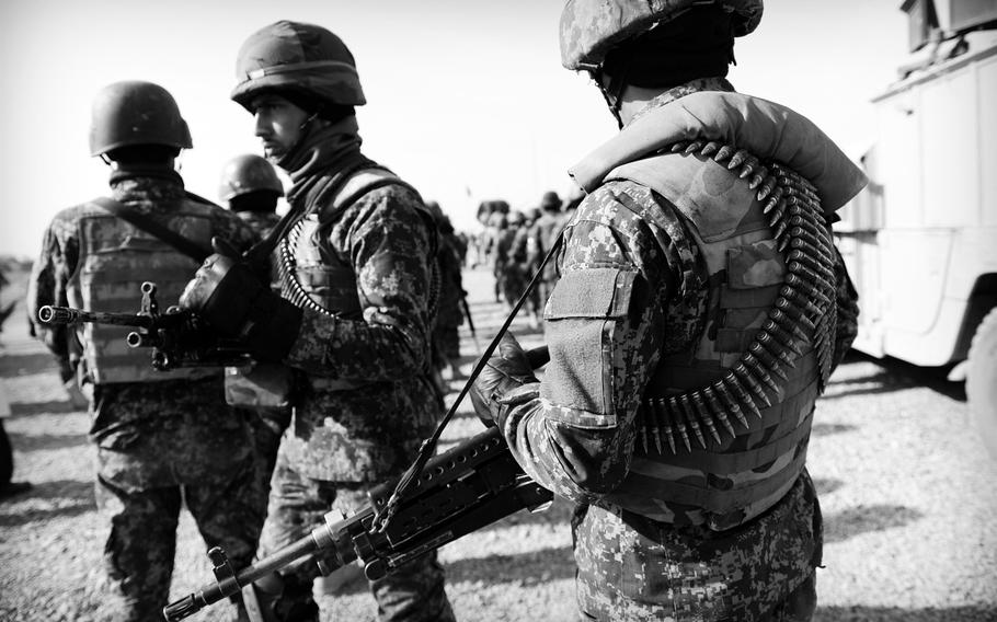 Afghan National Army soldiers join local police to patrol a village in Panjwai district in southern Afghanistan on Jan. 5, 2015. Once known as a hotbed of insurgent activity, residents and security officials alike say the district has become more supportive of the national government.