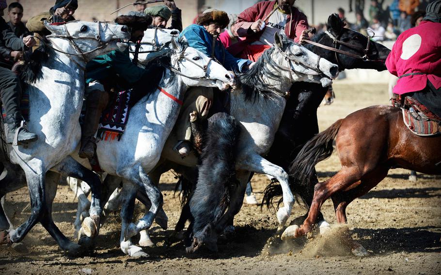 Afghan men on horseback compete in a buzkashi match on the outskirts of Kabul on Jan. 15, 2015. The game is the national sport of Afghanistan and was once banned under the Taliban.