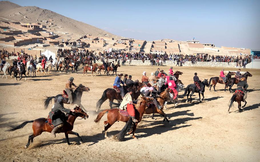 Dozens of Afghan men compete in a Buzkashi match on a clear afternoon outside Kabul, Thursday, Jan. 15, 2015. The game often has few concrete rules and can last as long as players and horses have the strength.