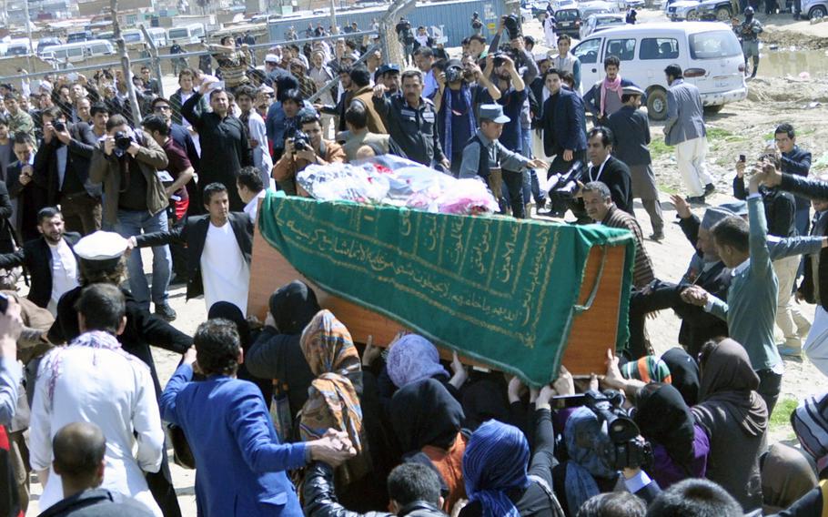 Women carry the coffin with the remains of 27-year-old Farkhunda, a young woman killed and then burned by a mob of men in downtown Kabul on March 19, 2015. The role of pallbearer is usually restricted to men, but women activists took the unusual step to show solidarity and protest violence against women.