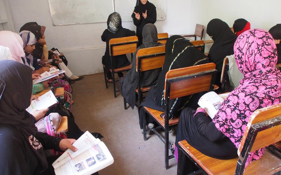 A teacher conducts a class at the Kandahar Institute of Modern Studies, a private co-educational school in a city that is the Taliban's spiritual heartland on July 17, 2014. Ehsanullah Ehsan, the school's founder, says he still gets death threats for his outspoken views on girls' education. 