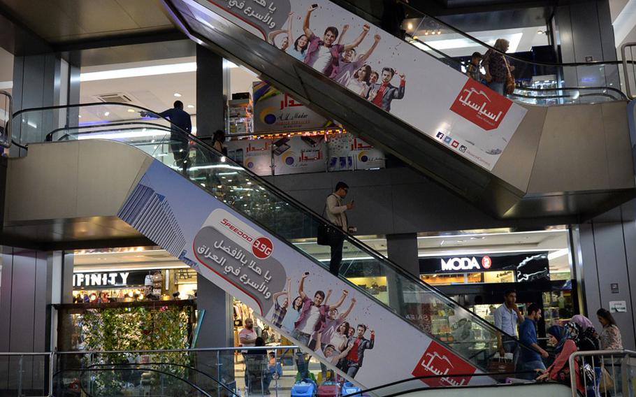 Shoppers take escalators inside Baghdad's Mansour Mall. The four-story mall features about 200 stores and restaurants and includes movie theaters and an indoor amusement park for kids.