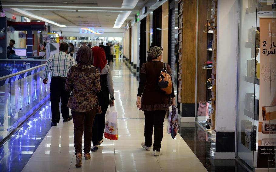 Women shoppers browse stores inside Baghdad's Mansour Mall. The glittering shopping center contrasts with the drab blast walls and concrete that mark most of the city.