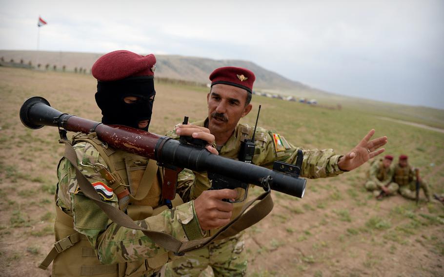 An instructor teaches a volunteer fighter how to operate a rocket-propelled grenade launcher at a camp in northern Iraq run by Turkish advisers and exiled leaders from Mosul. The makeshift camp can train as many as 1,000 fighters at a time.