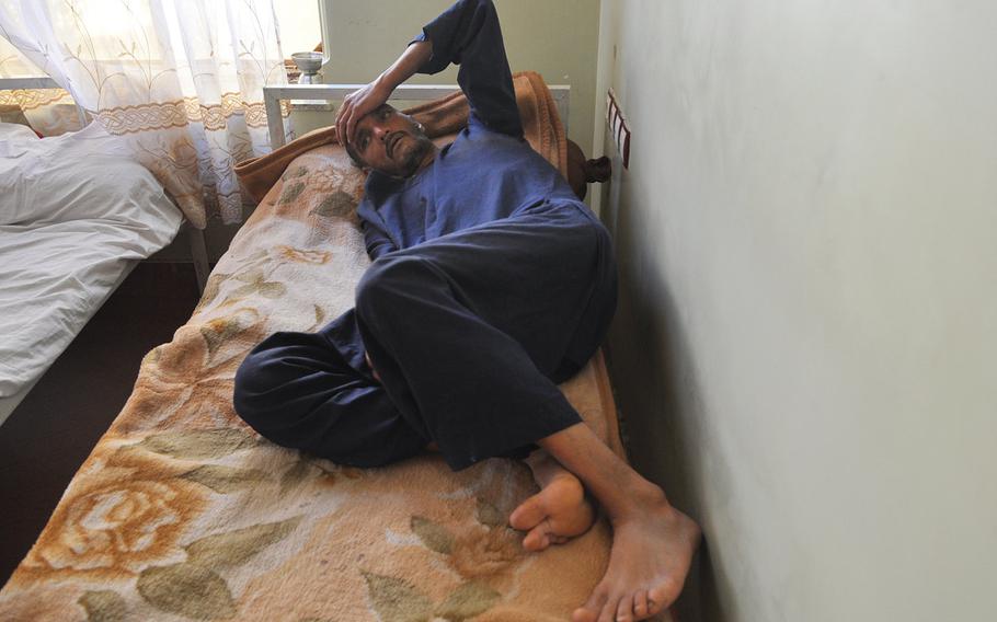 A heroin addict deals with the effects of withdrawal after checking into a drug rehabilitation clinic in Herat, Afghanistan in 2013.  More than one in 10 Afghans regularly uses illegal drugs according to  a survey released Tuesday, May 12, 2015.