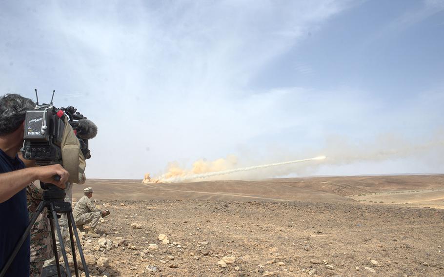 A cameraman films a Jordanian High Mobility Artillery Rocket System (HIMARS) on the Wadi Shadiya training range in Jordan on May 18, 2015, during an exhibition of American and Jordanian firepower before officials from both nations. The event is the culminating act of the exercise Eager Lion, which is held annually in Jordan to signal U.S. support for the key Middle East ally.