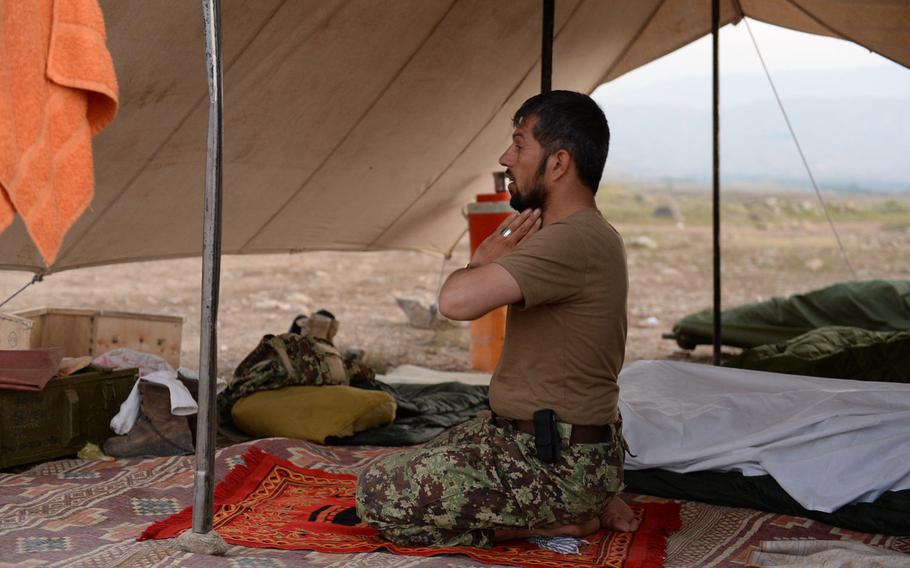 An Afghan soldier says his morning prayers at a forward camp during an operation in rural Nangarhar province in August 2015. Afghan forces have taken increasing losses as they have led the fight against the Taliban and other insurgents.