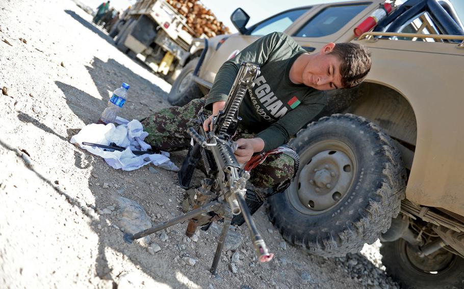 Naiemullah, an Afghan soldier with the 4th Brigade, 201st Corps, cleans his gun before a mission escorting a supply convoy in Nangarhar province in August 2015. From January through July of 2015, 4,302 Afghan National Security Forces were killed in action and another 8,009 were wounded, according to U.S. officials.