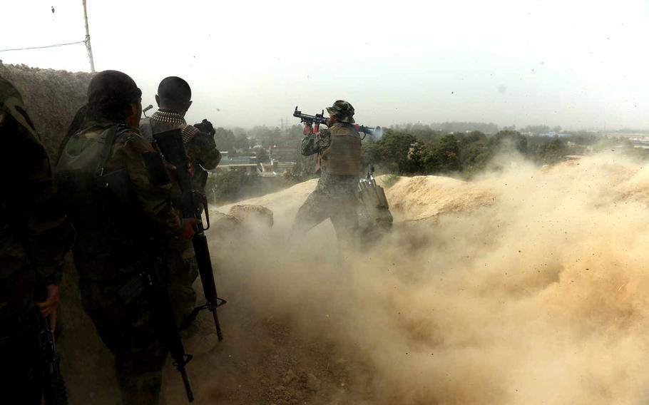 An Afghan soldier fires a rocket-propelled grenade at Taliban positions on the outskirts of Kunduz during mop-up operations in October 2015. It took nearly two weeks of house-to-house fighting before most pockets of Taliban resistance had been eliminated.