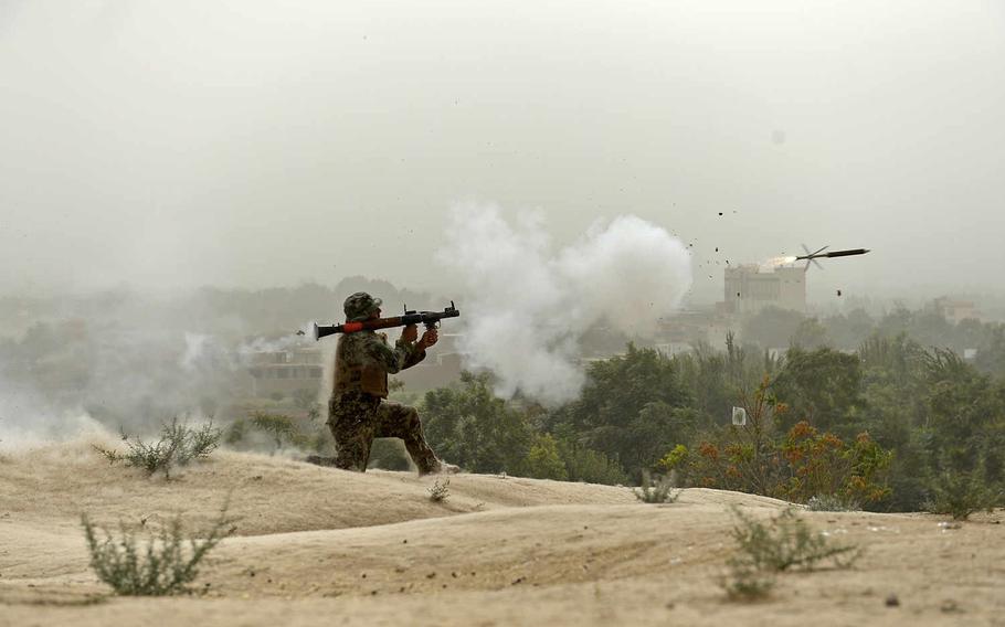 An Afghan soldier fires a rocket-propelled grenade at Taliban positions on the outskirts of Kunduz during mop-up operations in October 2015. Though security forces greatly outnumbered insurgents, the Taliban continued to threaten the area.