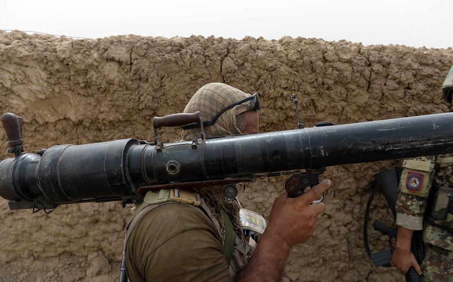 An Afghan army soldier carries a shoulder-fired rocket launcher to the front during an operation to clear Taliban from an area on the outskirts of Kunduz city. Neighborhoods often changed hands as security forces fought to dislodge the insurgents.