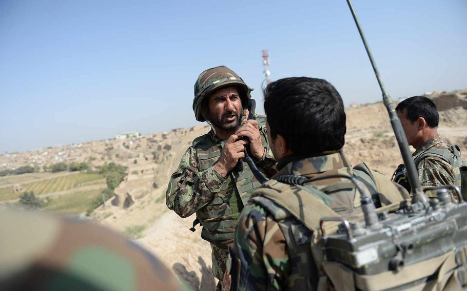 Brig. Gen. Ahmad Habibi, commander of the Afghan army's 2nd Brigade, 209th Corps, gives commands over his radio during a clearing operation on the outskirts of Kunduz city on Oct. 10, 2015. Habibi says the Taliban can now fight with nearly the strength they could before 2001.