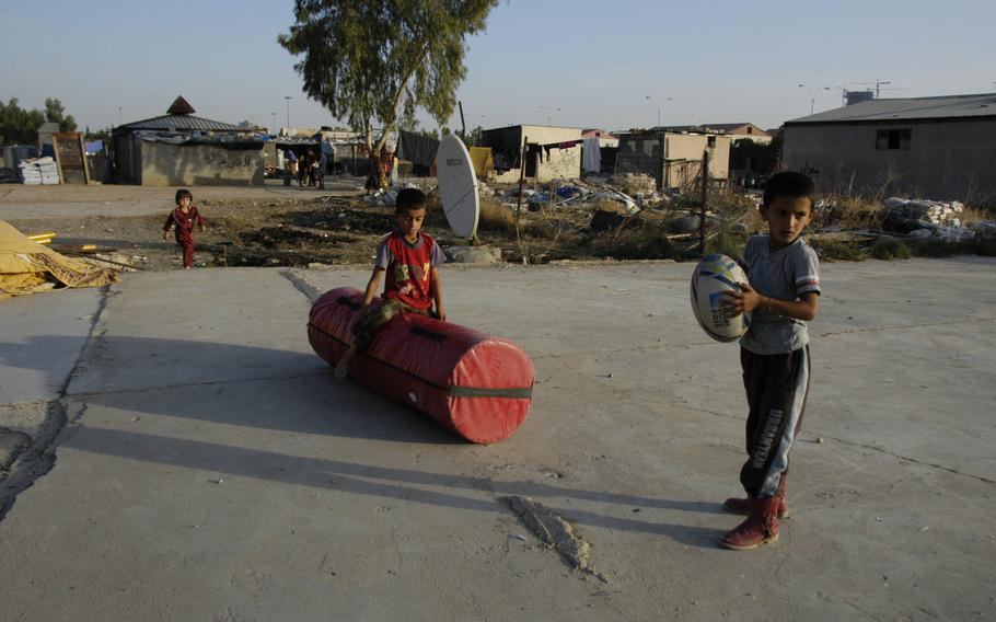 Yazidi children are seen with their rugby equipment at a camp for displaced people in Irbil, Iraq, on Oct. 25, 2015.