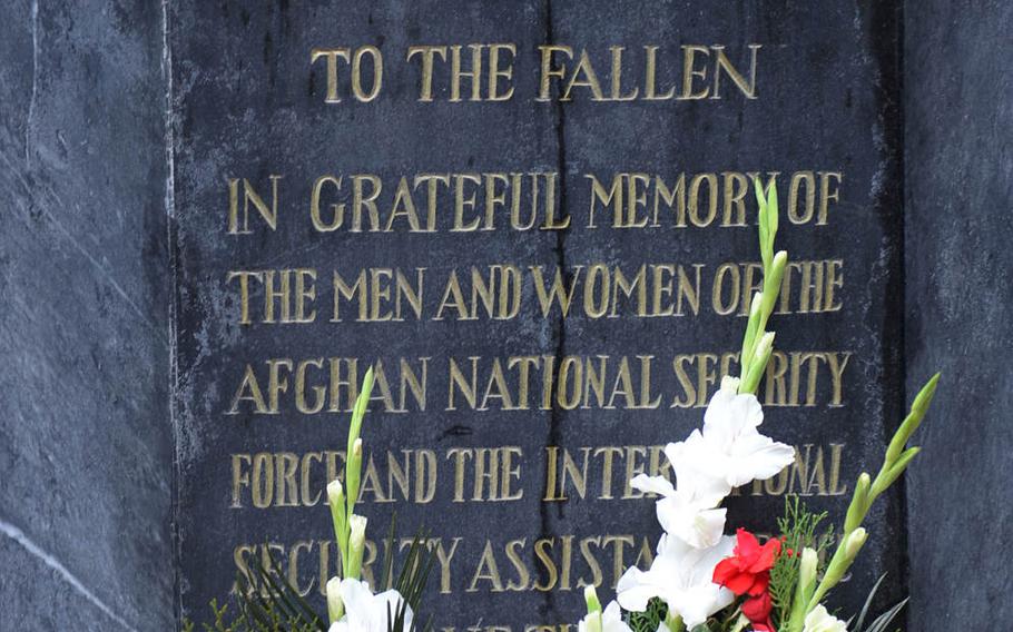 Flowers adorn a memorial to fallen coalition and Afghan soldiers at the Kabul headquarters of the NATO-led Resolute Support mission. Servicemembers laid wreaths on Wednesday, Nov. 11, 2015, to honor troops who died in past wars, as well as in the current conflict in Afghanistan.