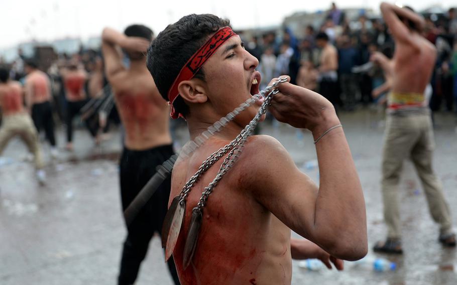 A young man flagellates himself at an Ashoura procession in Kabul, Afghanistan, Saturday, Oct. 24, 2015. For Shiites, Ashoura is one of the holiest days of the year.