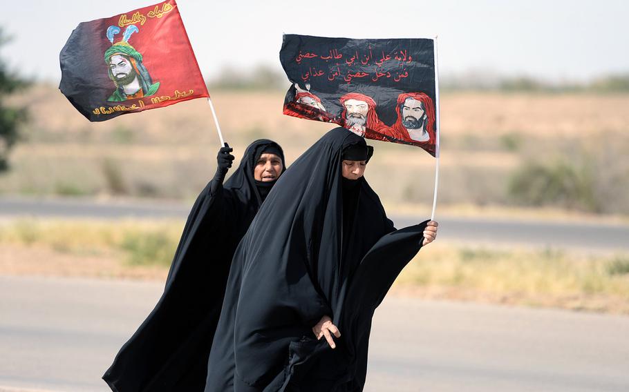 Two Shiite women walk along a highway during a pilgrimage from Baghdad to shrines in the city of Samarra on April 22, 2015. That same day a suicide car bomb went off next to a crowd of pilgrims as they were returning from Samarra, killing eight and wounding 16.