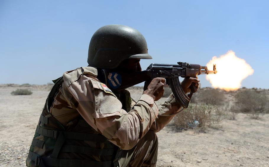 An Iraqi army soldier fires his rifle during a training exercise on April 26, 2015. The exercise, south of  Baghdad, was designed to build troops' confidence and educate them on threats they may face.
