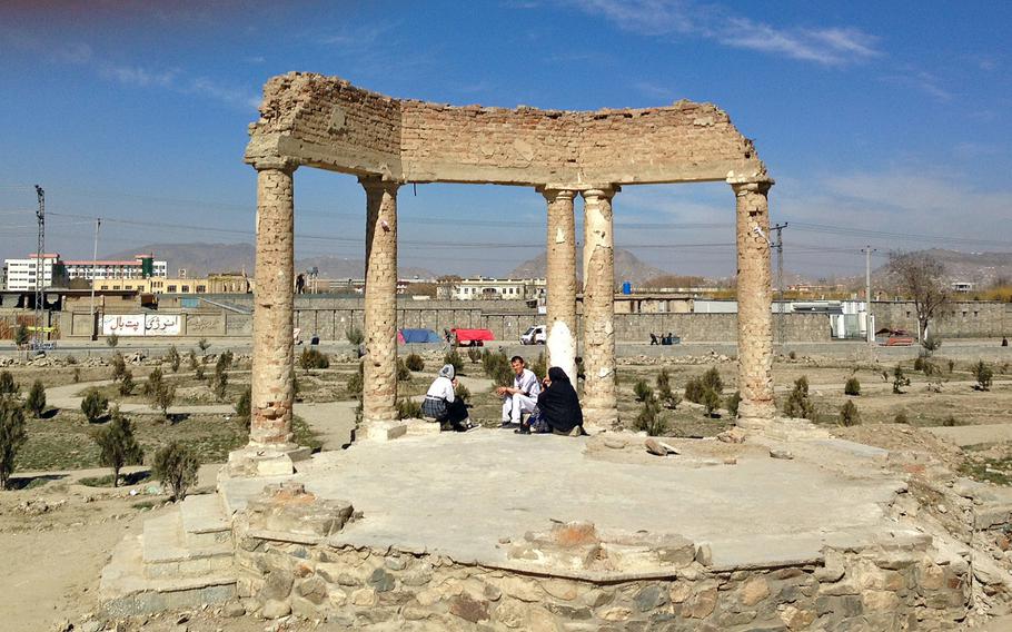 A family picnics beneath a destroyed gazebo in the gardens of Kabul's Darul Aman Palace, now in ruins, on Sunday, Feb. 28, 2016. The grounds of the palace, located on Kabul's western outskirts, are a popular weekend place for  residents of the Afghan capital. Renovation work on the palace has recently started.
